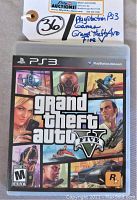 Front cover of Grand Theft Auto V PS3 game case showing artwork with characters and game title.
