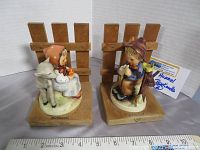 Front and side views of the MJ Hummel bookends featuring girl with lamb and boy with bird, with ruler for size reference.