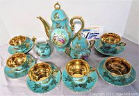 Full set view: coffee pot, creamer, sugar bowl, six cups and saucers