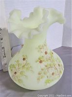 Front view showing ruffled top and floral decoration