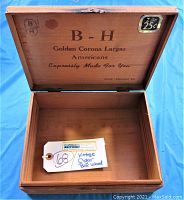 Open box showing interior printed branding and sticker tag