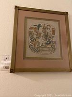 Front view of the framed Mexican print featuring two figures and stylized animals with traditional patterns.