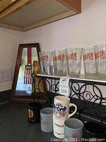 Michelin Light Beer mirror on countertop with Aviator Ales pint glasses and assorted mugs in front