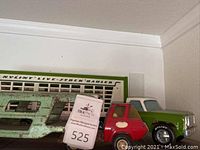 Side view of green Tonka livestock truck with red logo and attached green and white Nylint truck cab