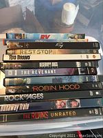 Stack of DVDs showing titles like RV, Ray, Rio Bravo, Reservoir Dogs, The Revenant, Robin Hood, Runaway Train, and The Ruins Unrated