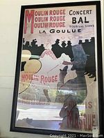 Framed Moulin Rouge concert poster showing vintage silhouette artwork and text, measures 62x39 inches.