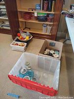 Overall view of storage bins containing vintage fruit décor, mason jars, and other kitchen items.