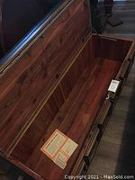 Open Lane cedar lined blanket chest/bench on wheels, showing cedar interior and vinyl tufted cover.
