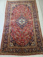 Top-down view of full rug showing overall design, colors, and condition