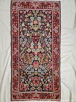 Full-length view of narrow runner rug on white sheet