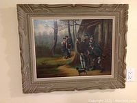 Full view of framed painting on wall showing entire forest scene and frame relief