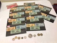 Overview of nine banknotes and coins laid out on a table.