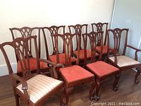Eight chairs arranged in two rows—six side chairs at rear, two armchairs front left and right