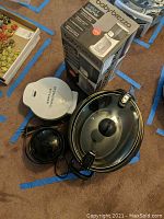 All four kitchen appliances in a view showing the Donut Maker, Crock-Pot Little Dipper, Crock-Pot standard and Baby Brezza Instant Warmer boxed.