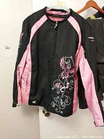 Front view of the ladies Honda Goldwing motorcycle jacket, black and pink nylon/polyester with decorative design