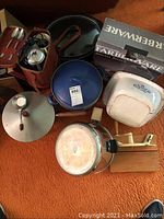 Overview of all items including Farberware crockpot box, cooking pots, coffee kit, waffle maker, and meat slicer.