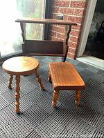 Front view of the wooden table with shelf and two stools on textured mat near window. Shows natural wood finish and overall condition.
