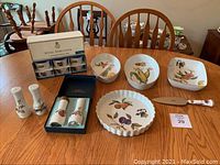 Photo showing full set arranged on table including 3 serving dishes, flan dish, ramekins in box, salt & pepper shakers, boxed salt shaker and pepper grinder, cake server