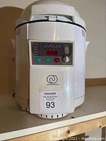 Front view of white Charlescraft bread maker showing control panel and branding
