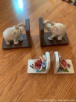 Pair of elephant bookends and pair of floral bookends shown together to depict lot contents