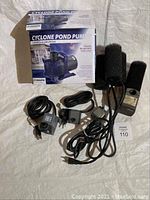 Full lot including Cyclone pond pump in box, two additional water pumps with power cords and sponge filter attachments.