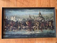 Front view of framed Riverside art print showing cityscape and water reflection