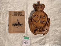 Wooden Canadian Coast Guard crest plaque and the 1953 instruction booklet together, showing lot contents.