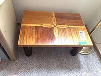 Top view of the rectangular wooden canoe wood table showing the central cross-shaped oval inlay pattern