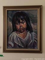 Framed portrait painting depicting a young girl with dark hair and expressive brushwork.