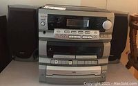 Full view of the stereo system showing the receiver, cassette player, CD player, and two speakers