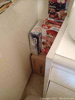 Photo showing stacked original boxes of Flippin Fantastic Pancakes maker, The Original Toy Candy Machine, Zyliss Easy Slice Grater and Westinghouse Blender.