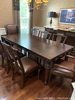Overall view of the eight chairs around a dining table in room setting