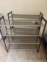 Four metal mesh shoe shelves arranged together, showing the stackable design and mesh shelving.