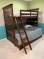 Full assembled bunk bed from front-left angle showing twin over full configuration and ladder placement