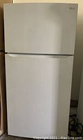 Full front view of the white LG top freezer refrigerator