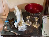 Full collection including bowl, candle sticks, spoons, and cup on black table