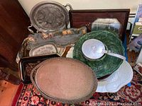 Photo showing multiple vintage trays, platters, baskets, including the Towle tray, a green leaf-shaped plate, and mirrored trays with some silvering loss.