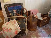 Photo shows sewing box with threads, knitted yarns, needlepoint artwork behind, and several woven baskets holding fabric and linens.