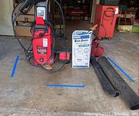 Front view of entire lot including Clean Force power washer, Hudson sprayer box, Toro leaf blower tubes, and mosquito screen roll.