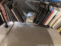Books arranged on a shelf, showing mostly art and painting related titles, some about watercolor and quilts.