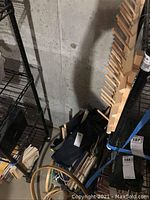 Shelf with stacked wooden dowel holders, embroidery hoops, and dowels for needlepoint and embroidery projects