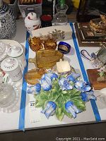 Wide shot of assorted porcelain and glass containers on table