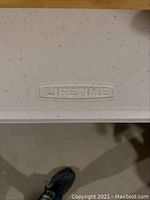 Close-up of speckled white plastic top showing Lifetime logo embossed on surface.