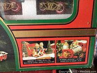 Close-up of box showing animated rocking elves car and working headlamp and sound features.