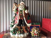 Front view of Fitz & Floyd Santa figurine with owl and kids Christmas tree and Kurt S. Adler Snowtown piece