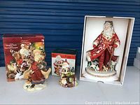 Overview of two Santa figurines with original boxes