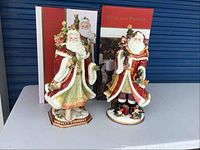 Both Santa figurines in front of their original Fitz & Floyd boxes