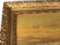 Close-up of ornate gold frame corner showing chip and wear.