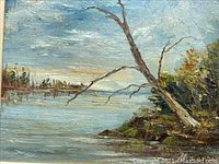 Framed oil painting showing landscape with tree, water, and sky.