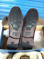 Bottom of Nunn Bush men's shoes showing the leather sole and rubber tread with Southern Style marking